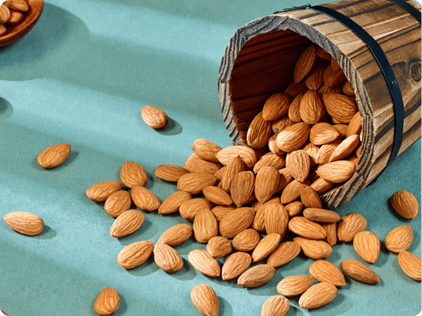 Almonds spilling from a small wooden barrel